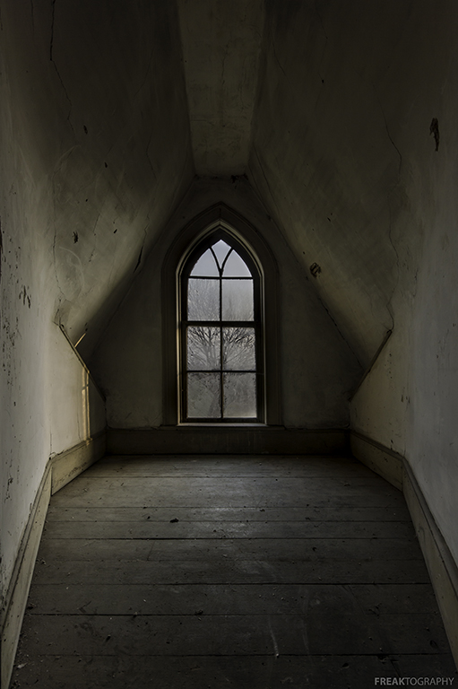 The attic window in an abandoned house in Ontario Canada. 
