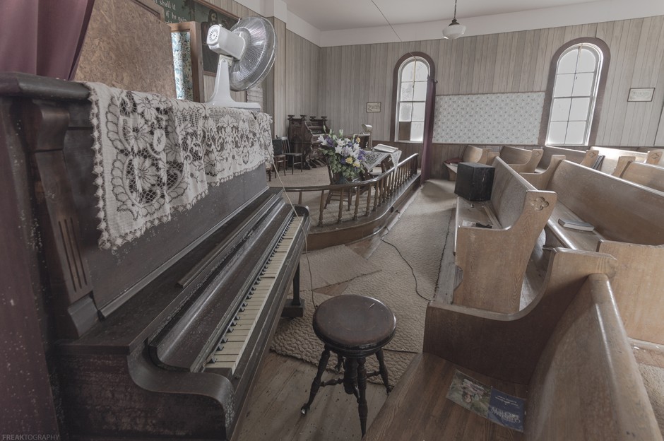 a piano in an abandoned church by freaktography