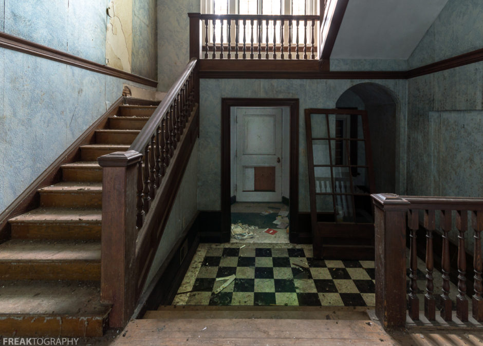 Freaktography, abandoned, abandoned mansion, abandoned mansion foyer, abandoned photography, abandoned places, arches, checkerboard floor, creepy, decay, derelict, foyer, haunted, haunted places, mansion, photography, railing, rule of thirds, stairs, urban exploration, urban exploration photography, urban explorer, urban exploring, wood