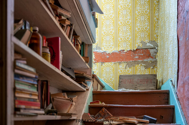 abandoned house stairs and bookshelf