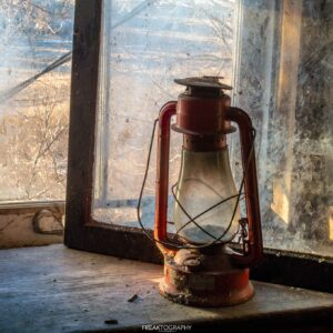 Red Lantern in Abandoned House Window