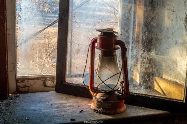 Red Lantern in Abandoned House Window