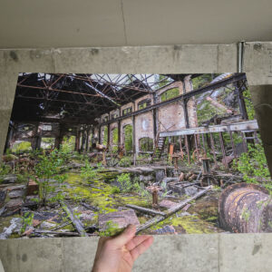 Rusted machinery and valve wheels scattered across a moss covered floor inside the ruined power plant at Anyox ghost town, British Columbia.
