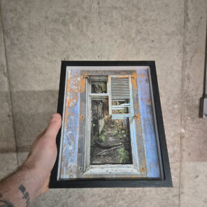 A weathered blue and orange window frame looking into rusted machinery inside the abandoned power plant in São Miguel, Azores, shown as a layered 3D photo.