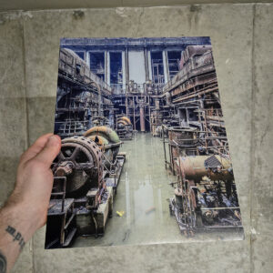 Flooded turbine hall filled with rusted machinery and pipes inside the abandoned Richmond Power Station.
