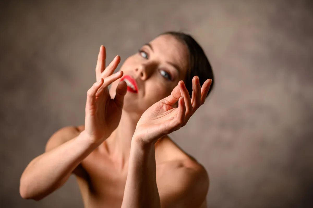 Creative beauty portrait with hands framing eyes and face