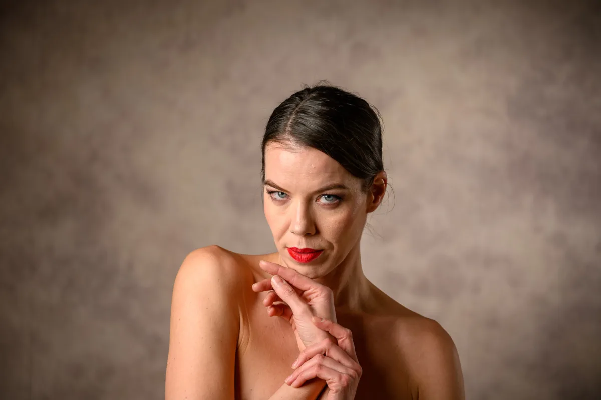 Minimal beauty portrait of woman with subtle pose and calm expression